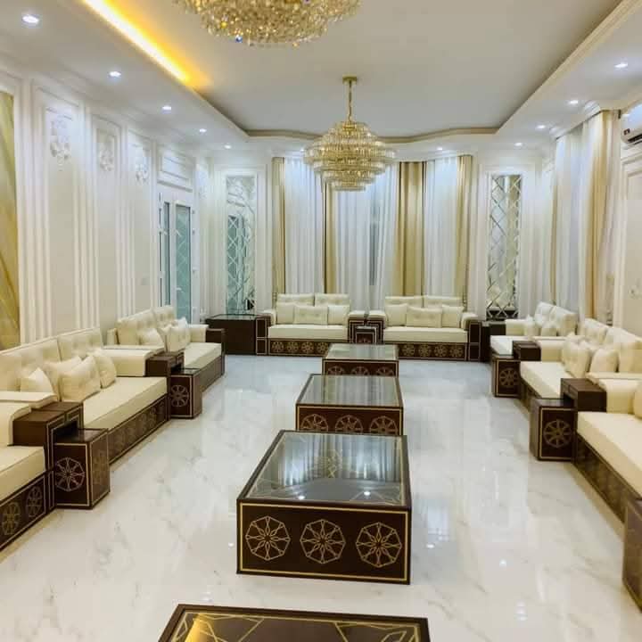Cream majlis with crystal chandeliers and mirrored wall panels