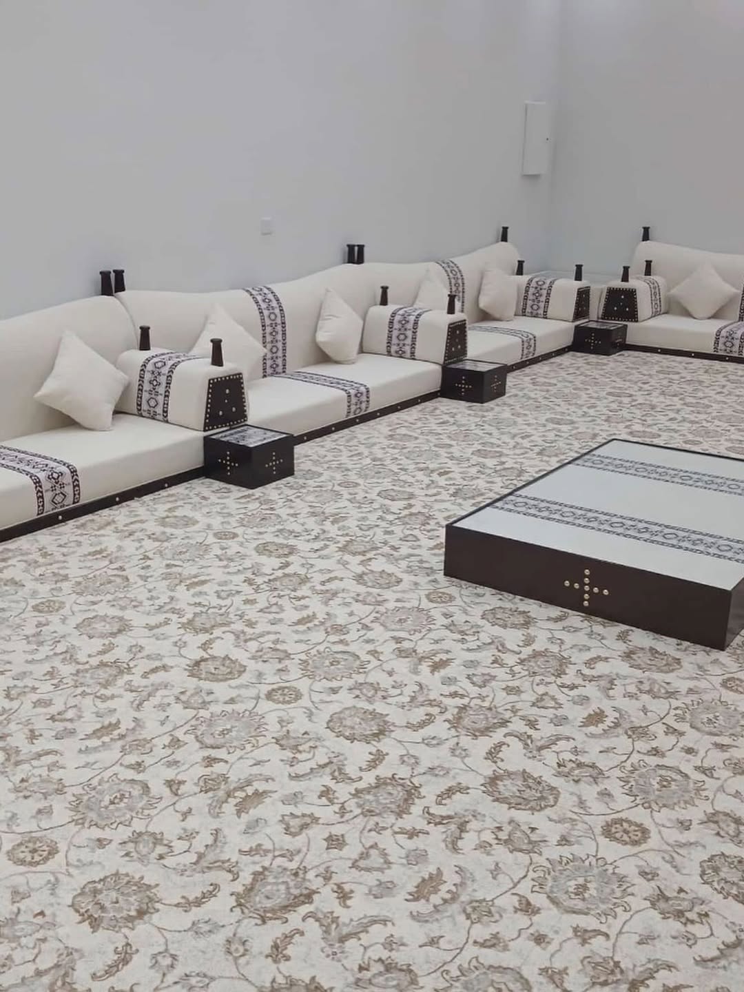 Traditional floor seating on a floral patterned carpet